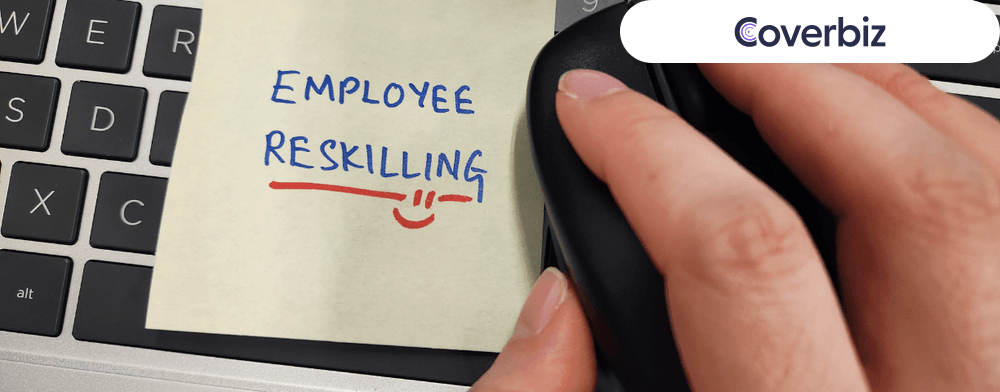 a hand placed on computer mouse with employee reskilling written under it