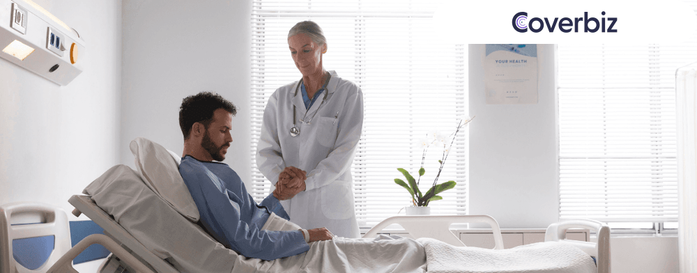 an old lady doctor standing near a patient and holding his hands