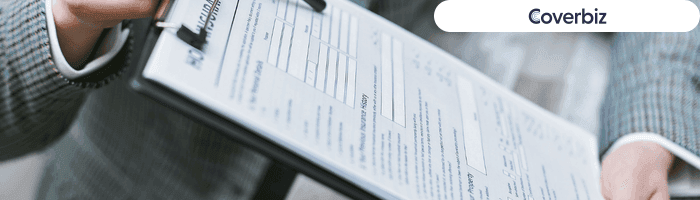 A person holding a clipboard which has a printed paper attached to it