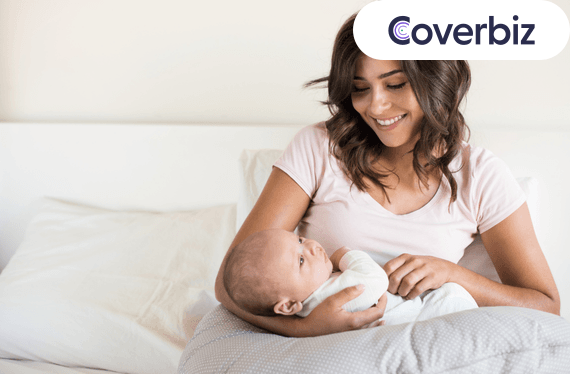 A mother is holding her newborn under maternity leave policy in India