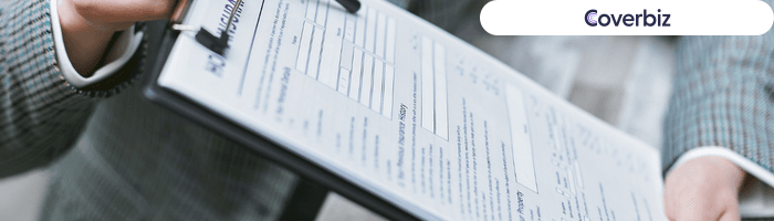 A person holding a clipboard which has a printed paper attached to it