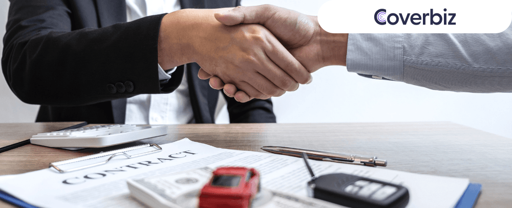 two people shaking hands of each other, a paper and a white calculator lying below